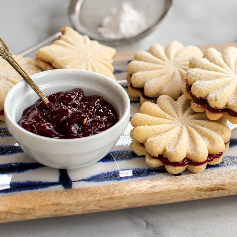Nordic Ware | Pretty Pleated Cookie Stamps: A plate of jam-topped cookies made with intricate imprints using the USA-crafted cookie stamps from Athens Cooks.
