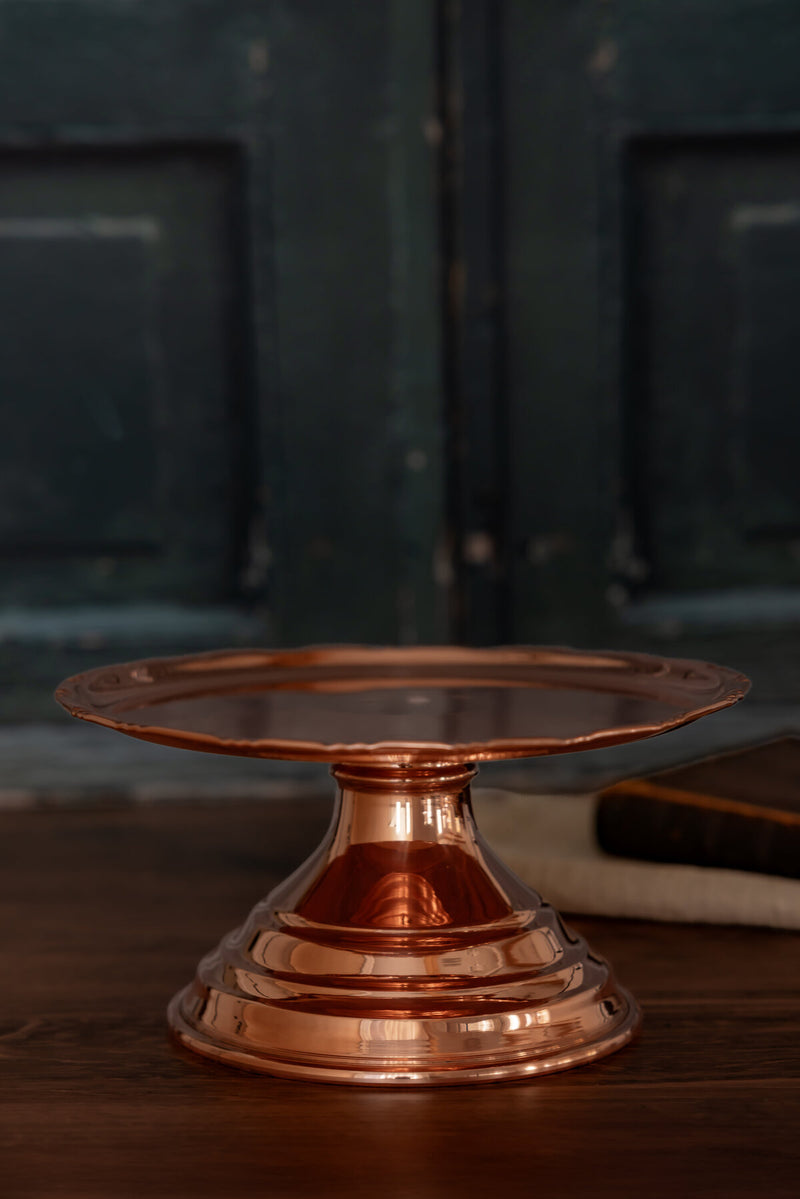 Coppermill Kitchen LLC | Vintage Inspired Cake Stand: Polished copper with scalloped edge and tiered base, perfect for displaying desserts or decor in an old-world kitchen style.