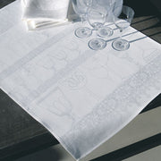 Le Jacquard Francais | Linen Crystal Towel, White, elegantly displayed on a dark wood table with matching napkins and stemmed wine glasses, showcasing its refined goblet motif.