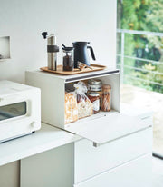 Yamazaki Home | Tower Bread Box, Steel, Black holds essentials, reducing clutter. Accessories include a coffee grinder and jam jar, enhancing kitchen organization.