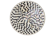 Novita Glass Mosaic Bowl with black and white square pattern, circular design, and glass material, enhancing home personalization. Dimensions: L. 26 cm, D. 26 cm, H. 5.5 cm.