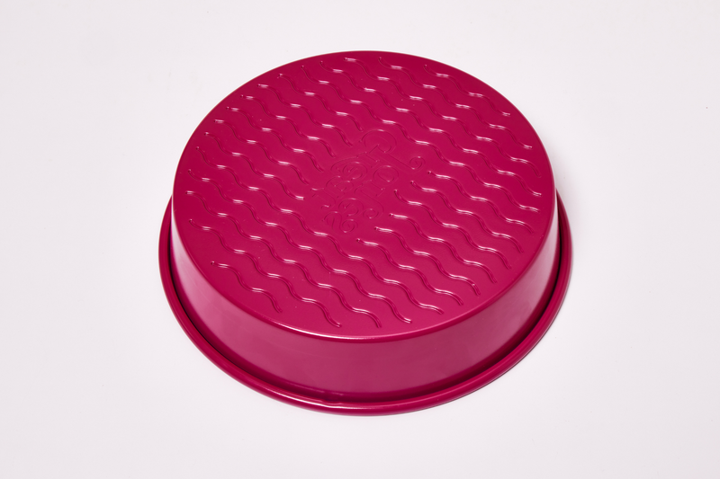 Great Jones | Patty Cake - Broccoli: Close-up of the wavy, corrugated stainless steel bottom, designed for nonstick baking and easy release of baked goods.