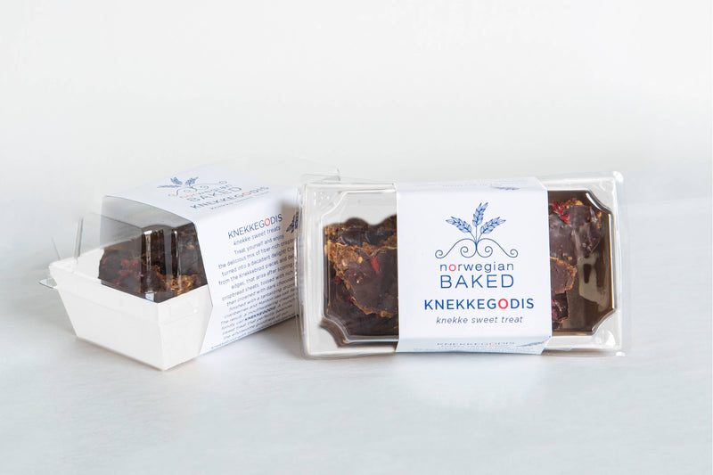 Norwegian Baked - KnekkeGodis, a sweet treat in a plastic container, featuring crispbread with caramel, dark chocolate, cranberries, and sea salt.