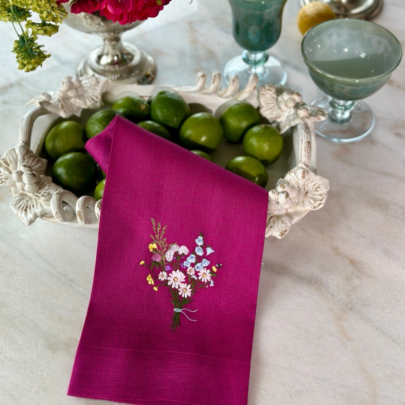 Wildflower Bouquet Linen Towel in a kitchen setting, featuring a bowl of limes and a glass, highlighting its decorative and functional appeal.