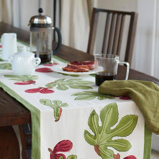 Couleur Nature - Fig Red/Green Table Runner on wooden table set with French press, coffee, sugar bowl, toast, and napkin, reflecting Athens Cooks' curated kitchen style.