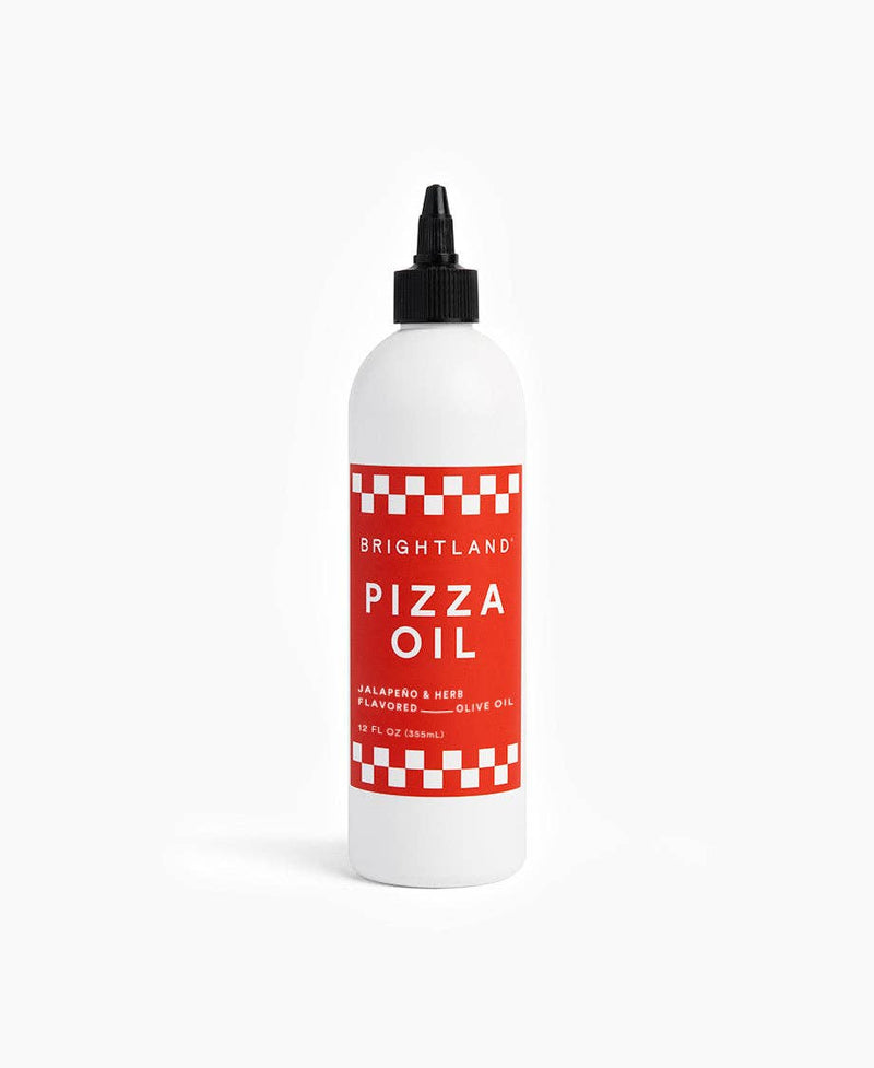 Brightland - Pizza Oil in a 12-fl-oz white bottle with a red checkerboard label, featuring a jalapeño and herb-infused olive oil for enhancing dishes.