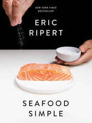 Cover of Seafood Simple: A Cookbook by Eric Ripert, featuring a raw salmon fillet on a plate with a hand sprinkling salt, emphasizing approachable gourmet seafood cooking.