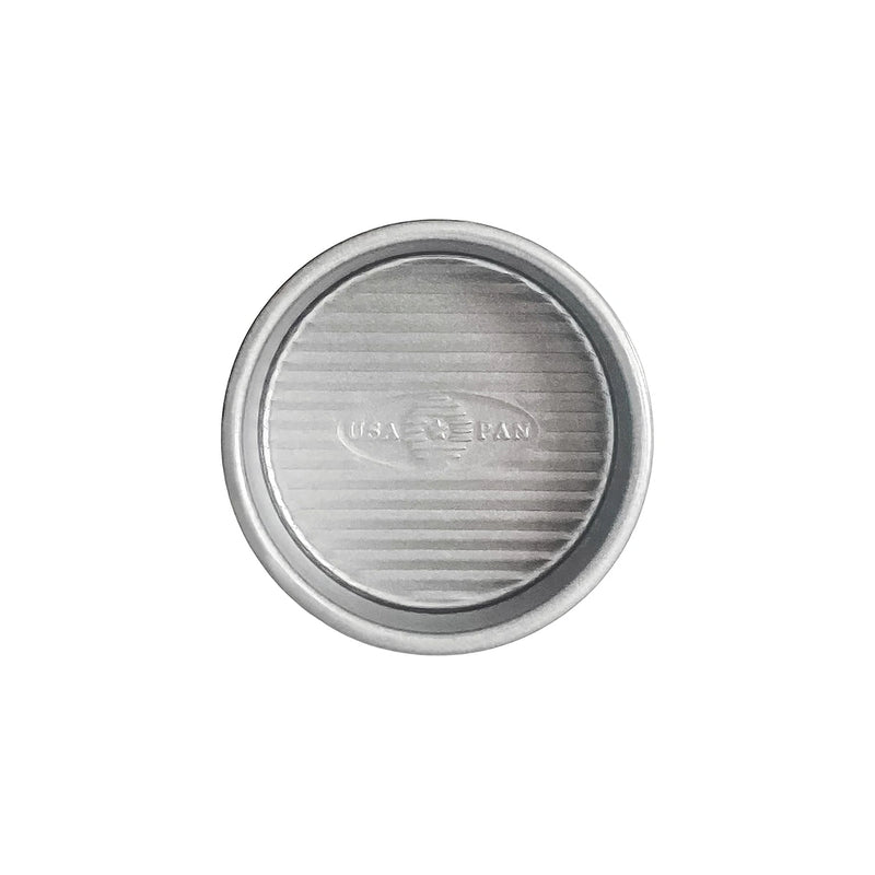 USA Pan | Cake Pans - 4 in Round, silver metal with embossed logo, features FDA-approved nonstick coating and ridged texture for even baking. Ideal for all bakers.