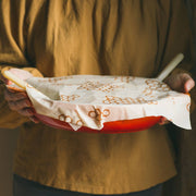 Bee's Wrap - Large 3 Pack Wraps shown covering a pan, highlighting its reusable, sustainable design made from organic cotton and beeswax.