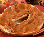 Southern Roots Sisters - Maple Pumpkin Butter spread on a plain bagel, highlighting its creamy texture and autumnal flavor, ideal for a seasonal breakfast or snack.