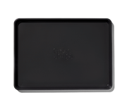 Great Jones | Holy Sheet - Blueberry: Black rectangular tray with logo, featuring nonstick ceramic coating for easy cleanup, ideal for kitchen and table use.