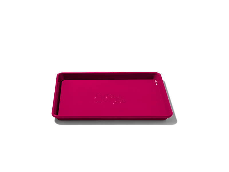 Great Jones | Little Sheet - Pepper, a compact, nonstick quarter-sized baking tray, ideal for small batch baking and reheating, showcased on a dark background.