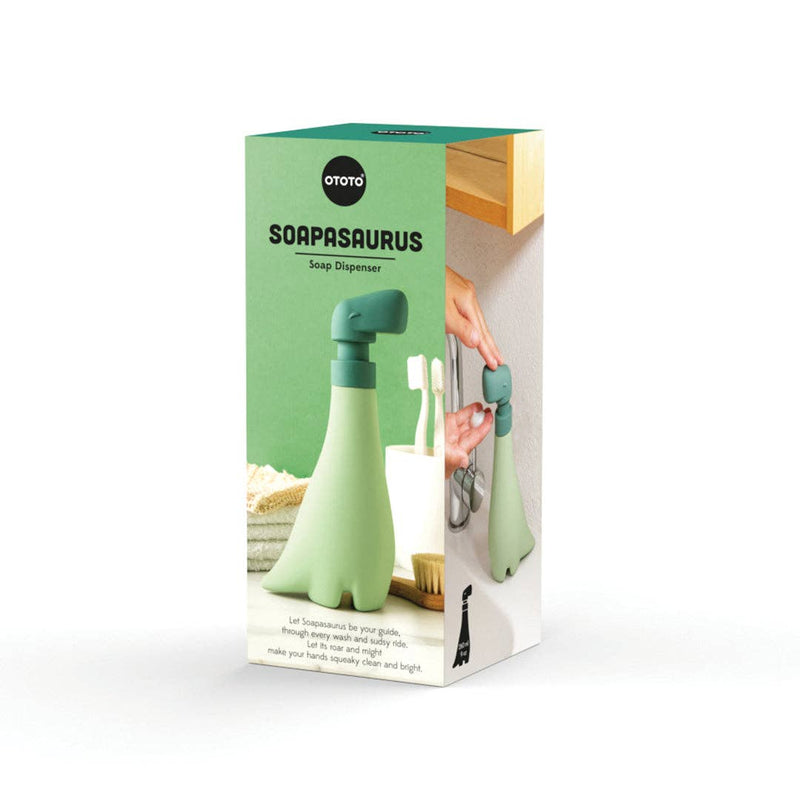 OTOTO - Soapasaurus soap dispenser, held in hand, showcased in a kitchen store setting, designed for fun and functional handwashing experiences.