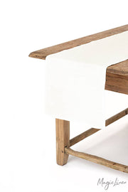 Linen table runner on wooden table, showcasing MagicLinen's versatile home textile, ideal for enhancing kitchen decor.