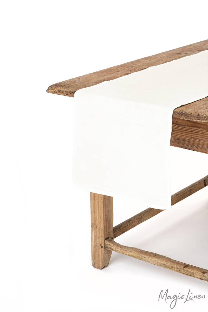 Linen table runner on wooden table, showcasing MagicLinen's versatile home textile, ideal for enhancing kitchen decor.