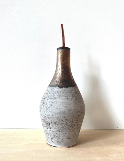 Jessica Wertz Ceramics - Grey + Gold Oil Bottle: Black, featuring a sleek ceramic design with speckled gray and metallic bronze finish, capped with a black lid and copper straw.