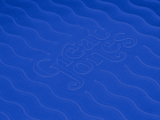 Great Jones | Patty Cake - Broccoli with wavy, corrugated bottom for easy release, showcased on a blue abstract fabric pattern.