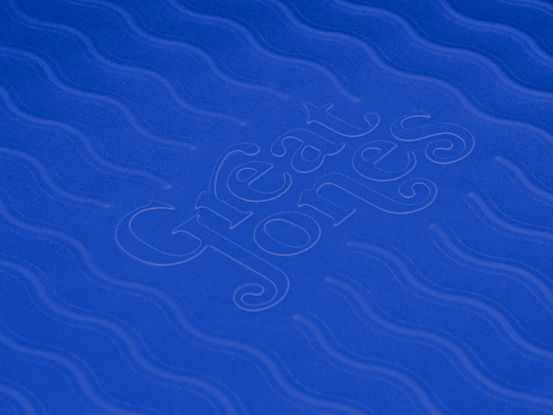 Great Jones | Patty Cake - Broccoli with wavy, corrugated bottom for easy release, showcased on a blue abstract fabric pattern.