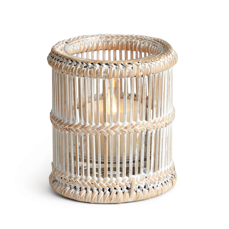 Napa Home & Garden - Burma Rattan Votive Holder, featuring a lit candle in an elegant wicker design, showcasing intricate patterns and open weave for ambient glow.