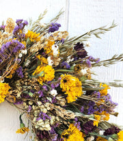 Alissas Flower Farm - Wreath: Spring Rain featuring yellow marigolds, purple statice on a base of pennycress and spring oats, perfect for indoor decoration.