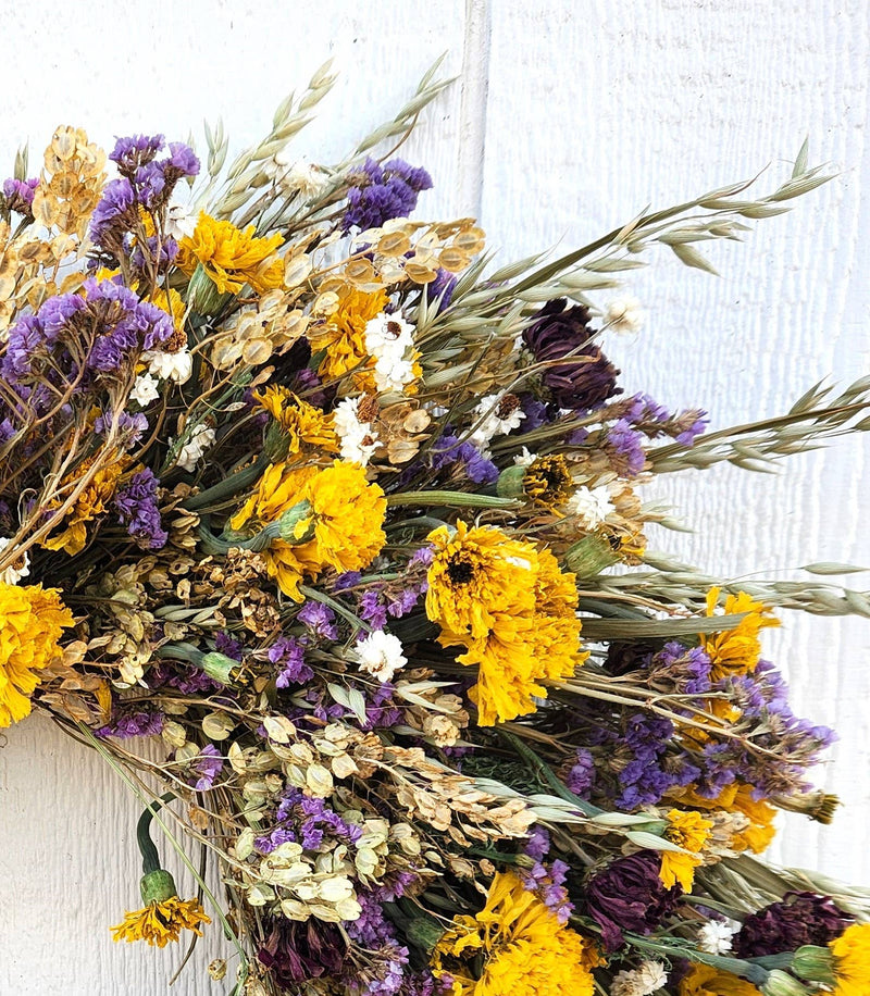 Alissas Flower Farm - Wreath: Spring Rain featuring yellow marigolds, purple statice on a base of pennycress and spring oats, perfect for indoor decoration.