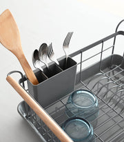 Yamazaki Home | Steel + Wood Dish Rack with Drainer Spout, featuring a utensil caddy and glass bowls, elegantly air-dries kitchenware on your countertop.