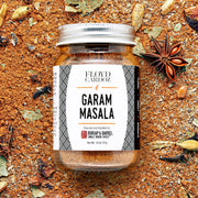 Burlap & Barrel - Garam Masala - Single Origin Spice & Seasoning Blend in a glass jar, surrounded by whole spices, perfect for authentic Indian cooking.