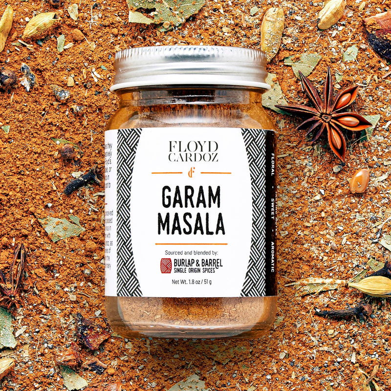 Burlap & Barrel - Garam Masala - Single Origin Spice & Seasoning Blend in a glass jar, surrounded by whole spices, perfect for authentic Indian cooking.