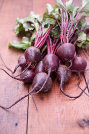 Bentley Seed Co. - Beets-Detroit Dark Red 1892: Fresh beetroots with leafy greens on wood, ideal for heart health and gardening.