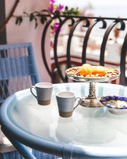 Farmhouse Pottery - Silo Espresso Cup: Single displayed on a balcony bistro table with mixed nuts, apricots, and a colorful dish, embodying Athens Cooks' curated kitchen elegance.