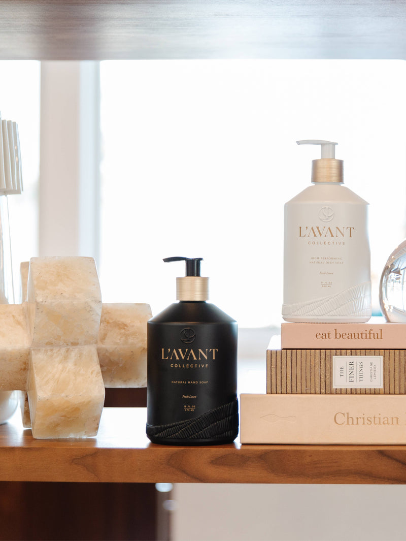 L'AVANT Collective - Fresh Linen Hand Soap in a matte black, reusable glass bottle, displayed on a shelf, emphasizing eco-luxe hand washing with a rich lather.