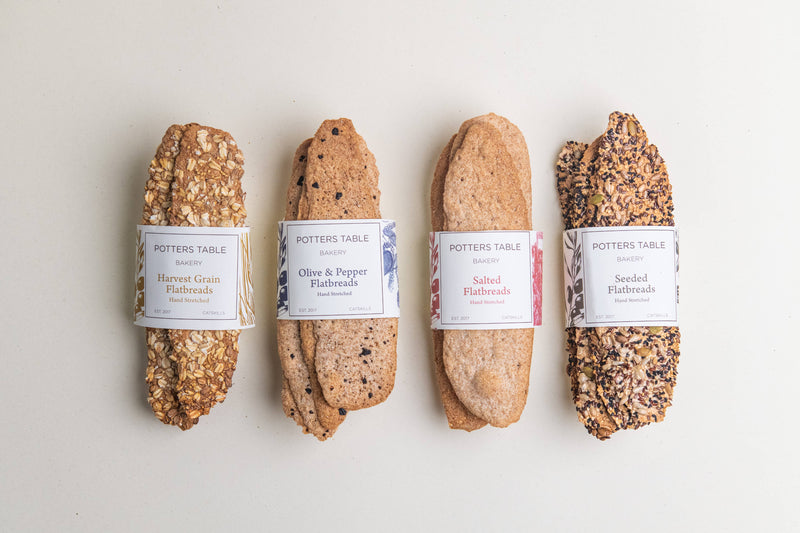 Potter’s Table - Seeded Olive Oil Flatbreads, hand-stretched and topped with a seed blend, perfect for gourmet gatherings. Ideal for cheese boards or elegant dining.