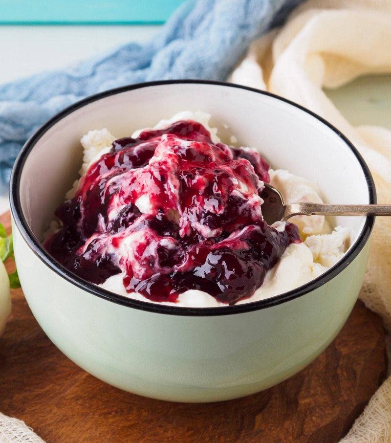 Southern Roots Sisters - Triple Berry Jam atop creamy vanilla ice cream, showcasing a rich berry sauce perfect for enhancing desserts or breakfast dishes.
