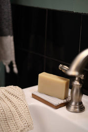 Gravesco Pottery - Soap Dish | White, a handcrafted ceramic dish on a sink, elevates soap, enhancing longevity. Ideal for kitchen or bathroom, unique variations in every piece.
