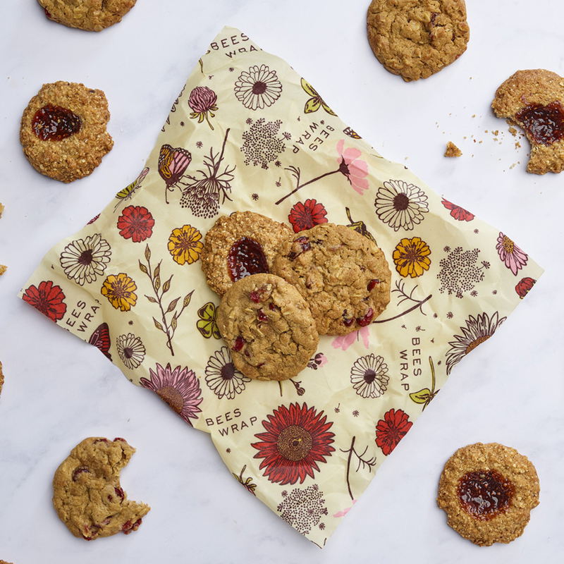 Bee's Wrap - Cut-to-Size Roll - Meadow Magic displayed with homemade cookies, showcasing its versatility and sustainability as a reusable, plant-based food wrap.