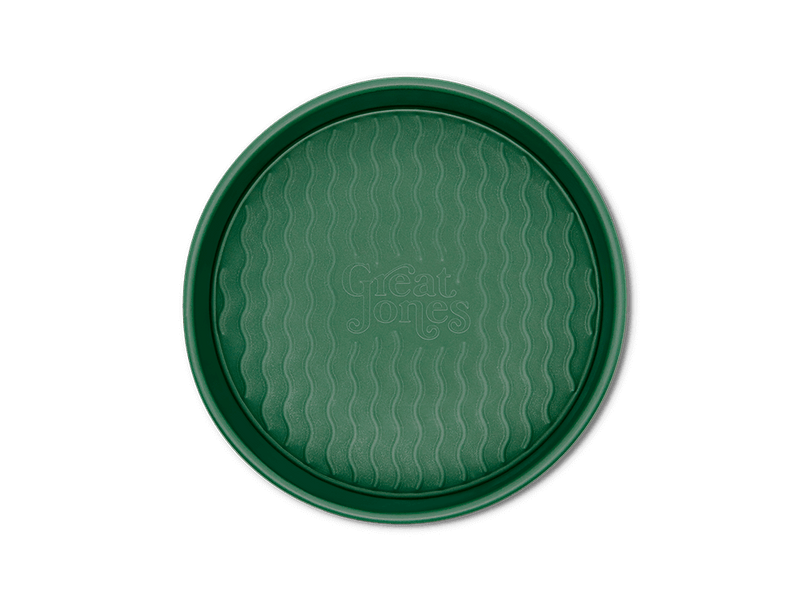 Great Jones | Patty Cake - Broccoli, a round tray with a wavy pattern, designed for easy release and even baking.