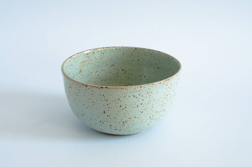 RachaelPots - Laura Bowl: Light Blue. Hand-thrown ceramic bowl with mint-green glaze and brown speckles; ribbed exterior for grip. Ideal for layered meals; microwave and dishwasher safe.