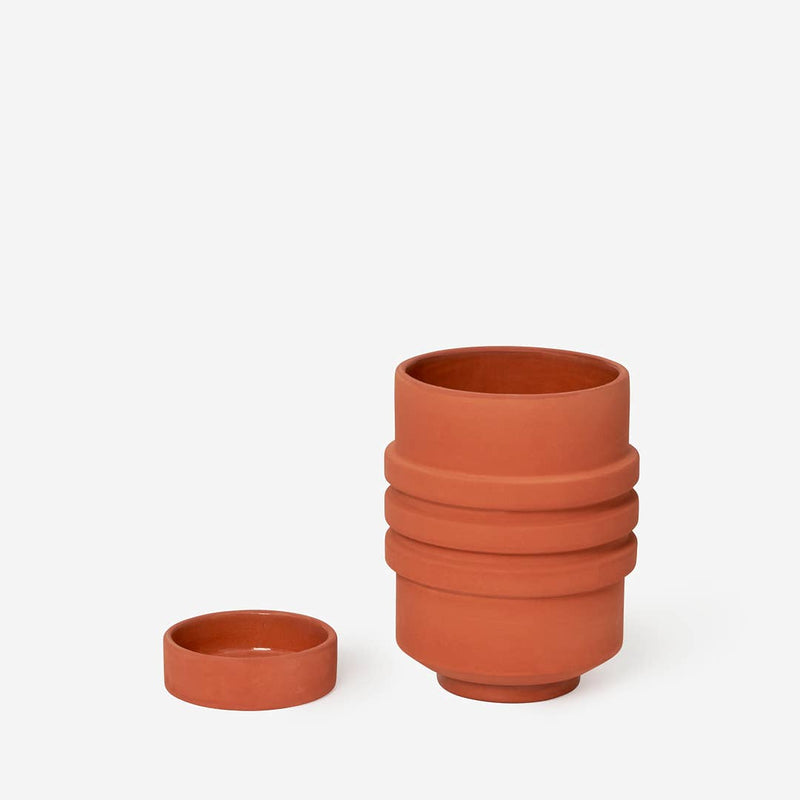 Areaware - Strata Plant Vessel: Yellow features a close-up of its sculptural ceramic design, showcasing layered shapes that seamlessly incorporate a hidden saucer.