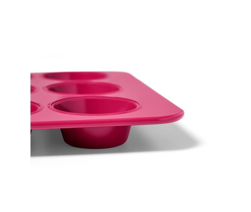 Close-up of the Great Jones | Stud Muffin - Blueberry, a nonstick muffin pan designed for even heat distribution, fitting 12 standard-size muffins.