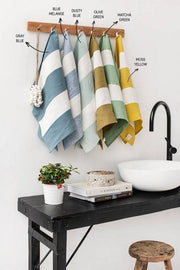 MagicLinen - Striped Linen Tea Towel hangs on a wooden bar near a sink, embodying eco-friendly, zero-waste design.