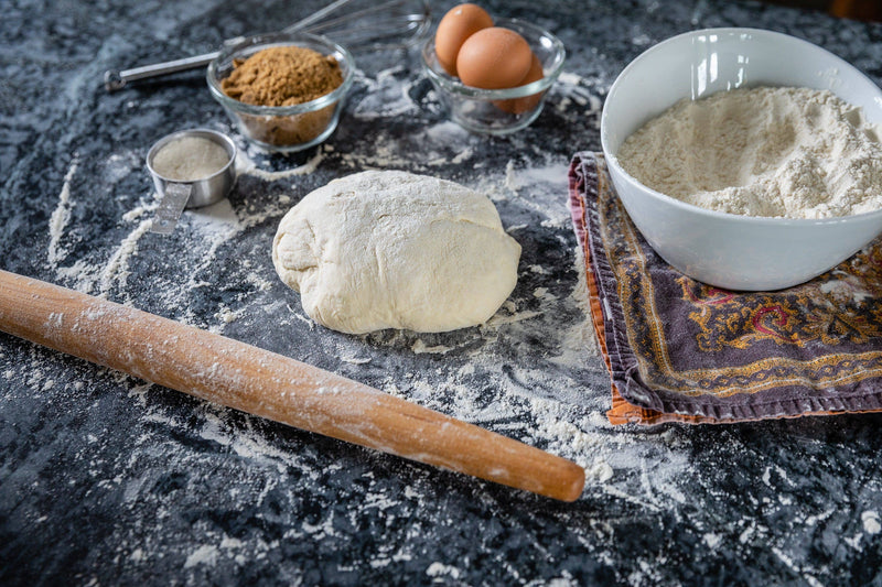 Earlywood | French Rolling Pin - Jatoba, elegantly contoured for maneuverability, is displayed with baking essentials, embodying the craftsmanship expected at Athens Cooks.