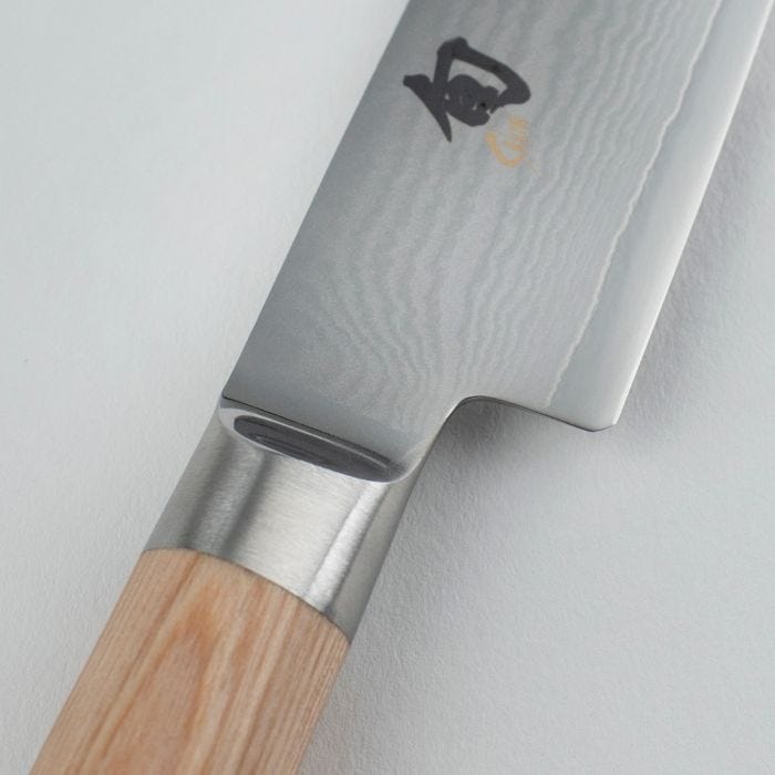 Shun Classic Blonde Utility Knife, 6 inches, showcases a Damascus-patterned blade and straight-grained wooden handle, ideal for precise, versatile kitchen tasks.