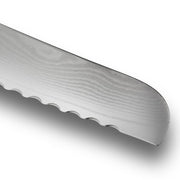 Close-up of the serrated edge of a Shun Classic Blonde Bread Knife, 9 inches, featuring scalloped teeth and Damascus-style grain pattern, ideal for slicing bread effortlessly.