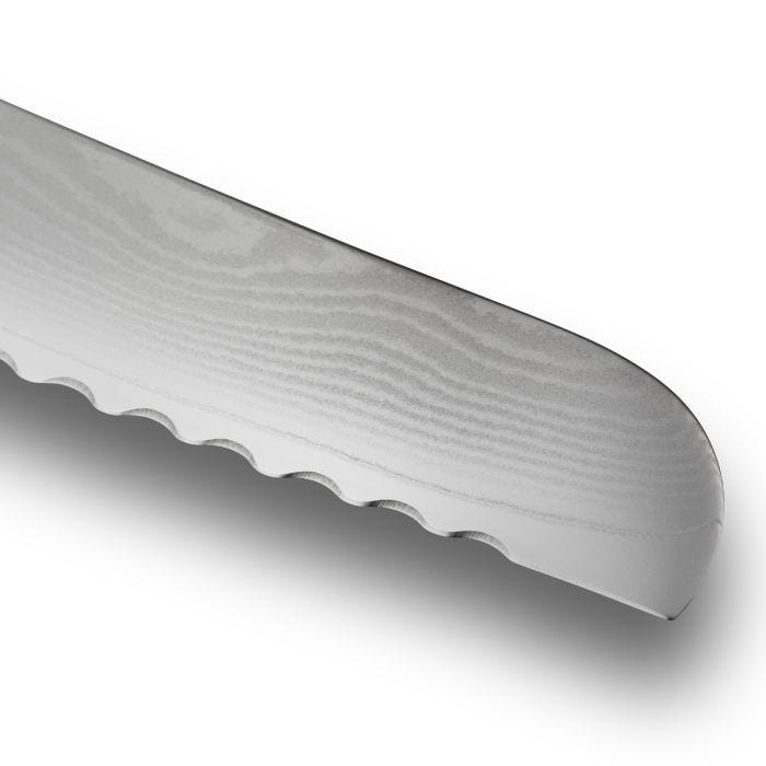 Close-up of the serrated edge of a Shun Classic Blonde Bread Knife, 9 inches, featuring scalloped teeth and Damascus-style grain pattern, ideal for slicing bread effortlessly.