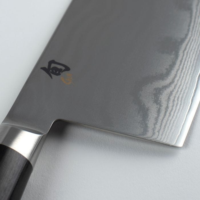 Shun | Classic Vegetable Cleaver, 7 inches, showcases a broad blade with Damascus pattern and dark handle, ideal for slicing vegetables and proteins. Handcrafted in Japan.