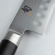 Shun Classic Hollow Ground Santoku, 7 inches, featuring a hammered Damascus finish and octagonal Pakkawood handle, ideal for versatile kitchen use.