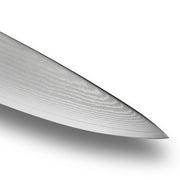 Close-up of the Shun Classic Chef's Ebony 6-inch knife tip, showcasing its Damascus steel blade's distinct layered grain and sharpness.
