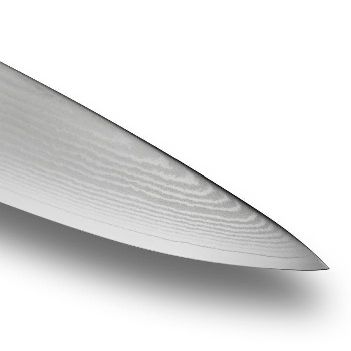 Close-up of the Shun Classic Chef's Ebony 6-inch knife tip, showcasing its Damascus steel blade's distinct layered grain and sharpness.