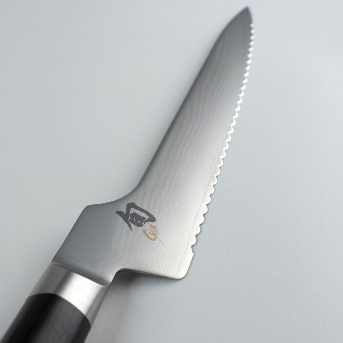 Shun Classic Offset Bread Knife, 8.25 inches, with serrated Damascus blade and dark wood handle, designed for precise slicing without knuckle interference.