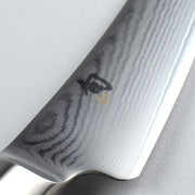 Shun | Classic Boning & Fillet knife close-up, showcasing its 6-inch Damascus steel blade with wood-grain pattern and Japanese logo, ideal for precise meat and fish preparation.
